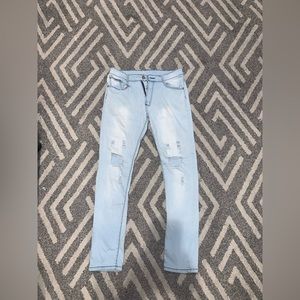 Size 34W ripped blue jeans.